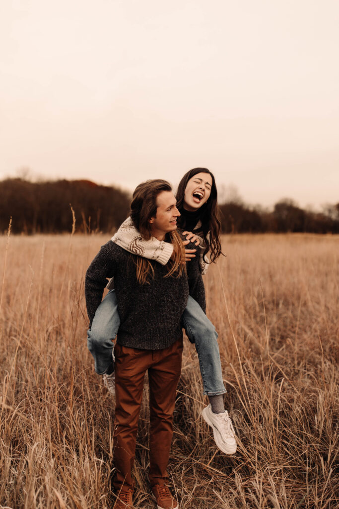 fall engagement photos in tall grass in iowa